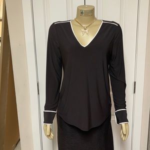 Black long sleeve stretch blouse with white piping.